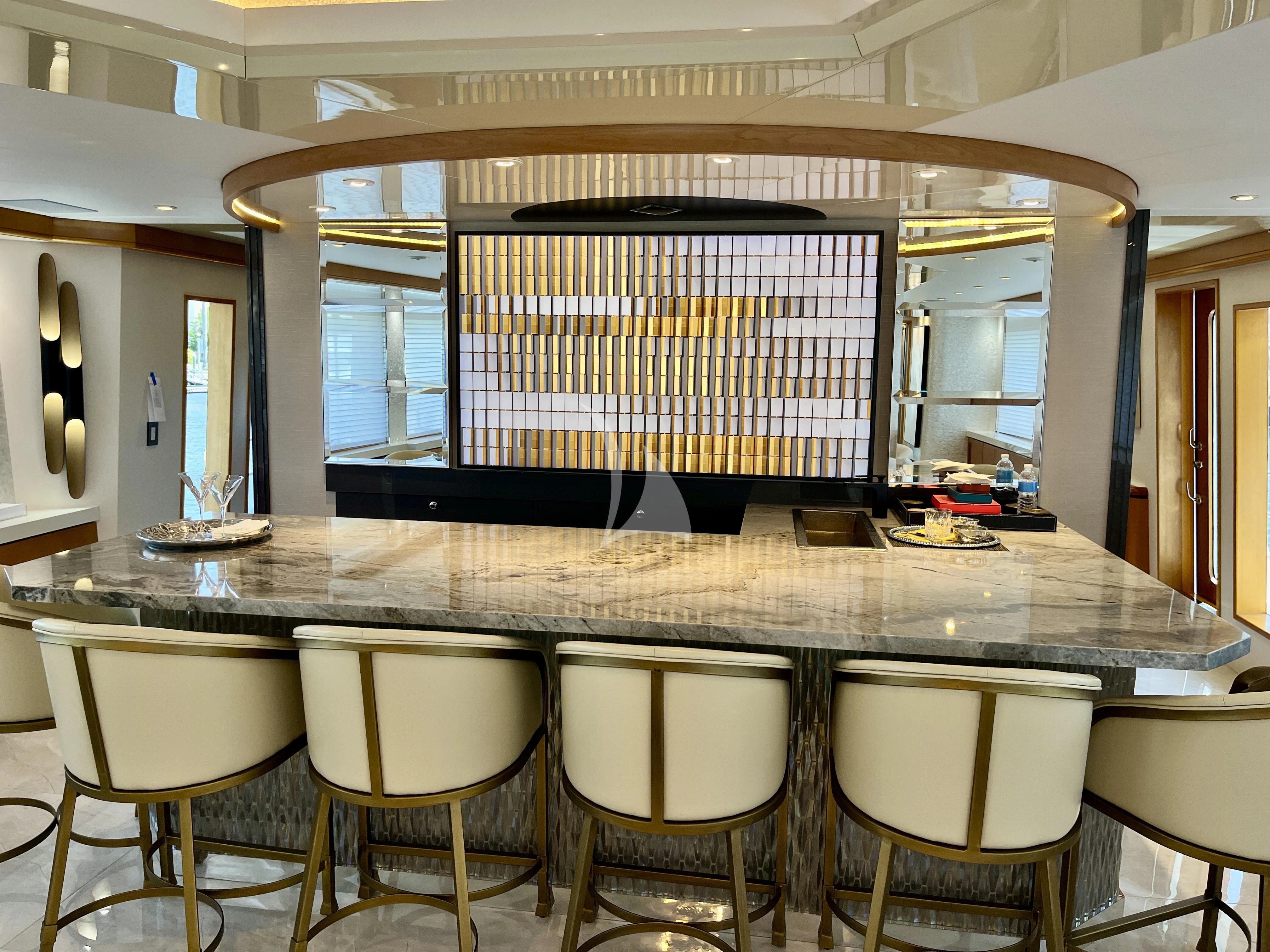 a large table with chairs aboard XOXO Yacht for Charter