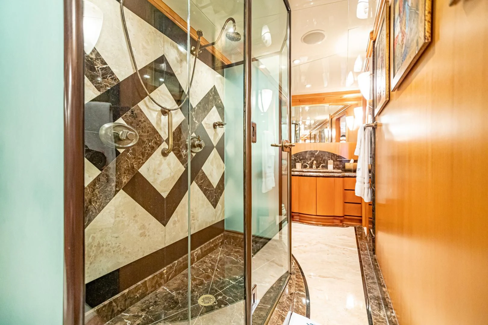 a bathroom with a glass shower aboard XOXO Yacht for Charter