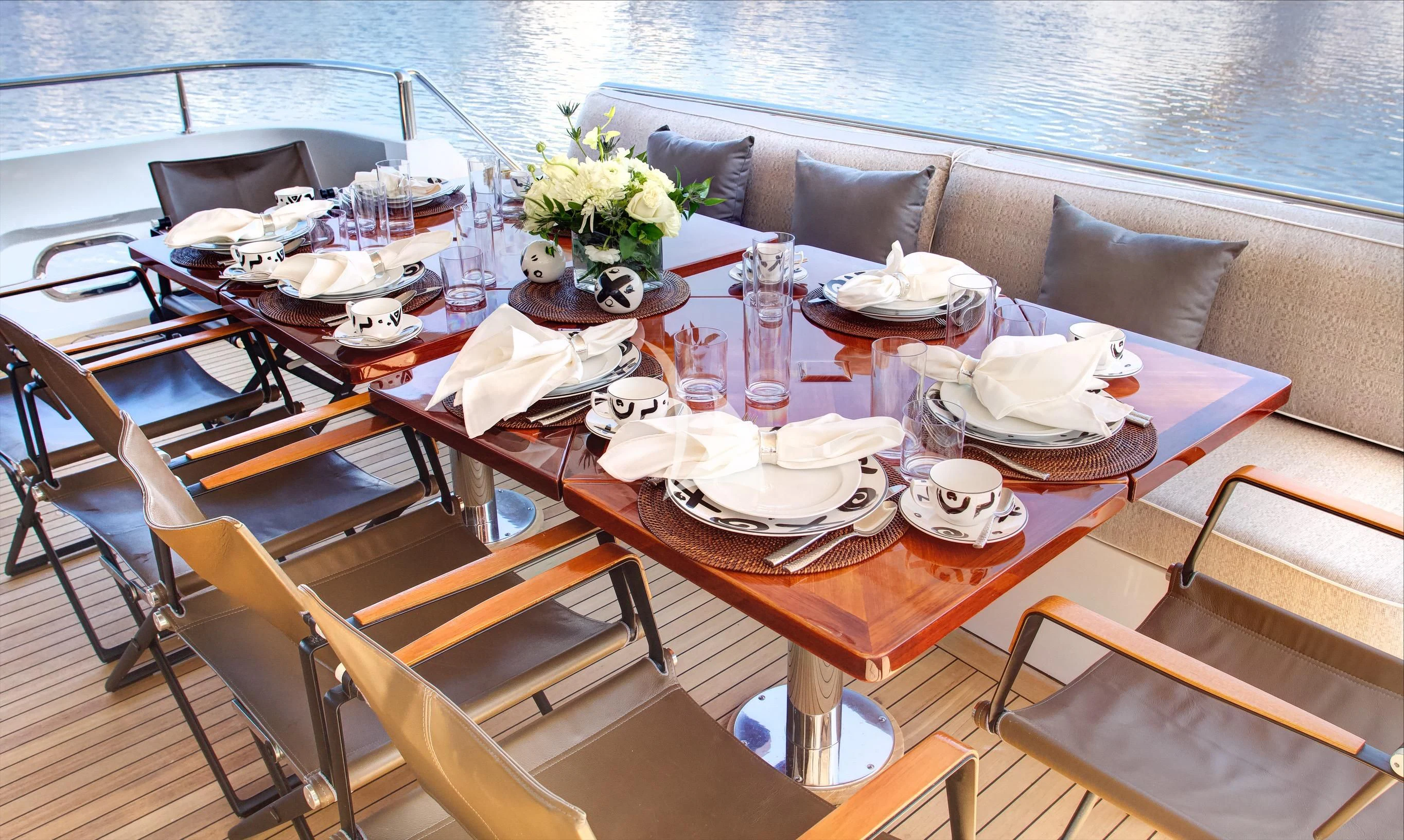a table with plates and glasses on it aboard XOXO Yacht for Charter