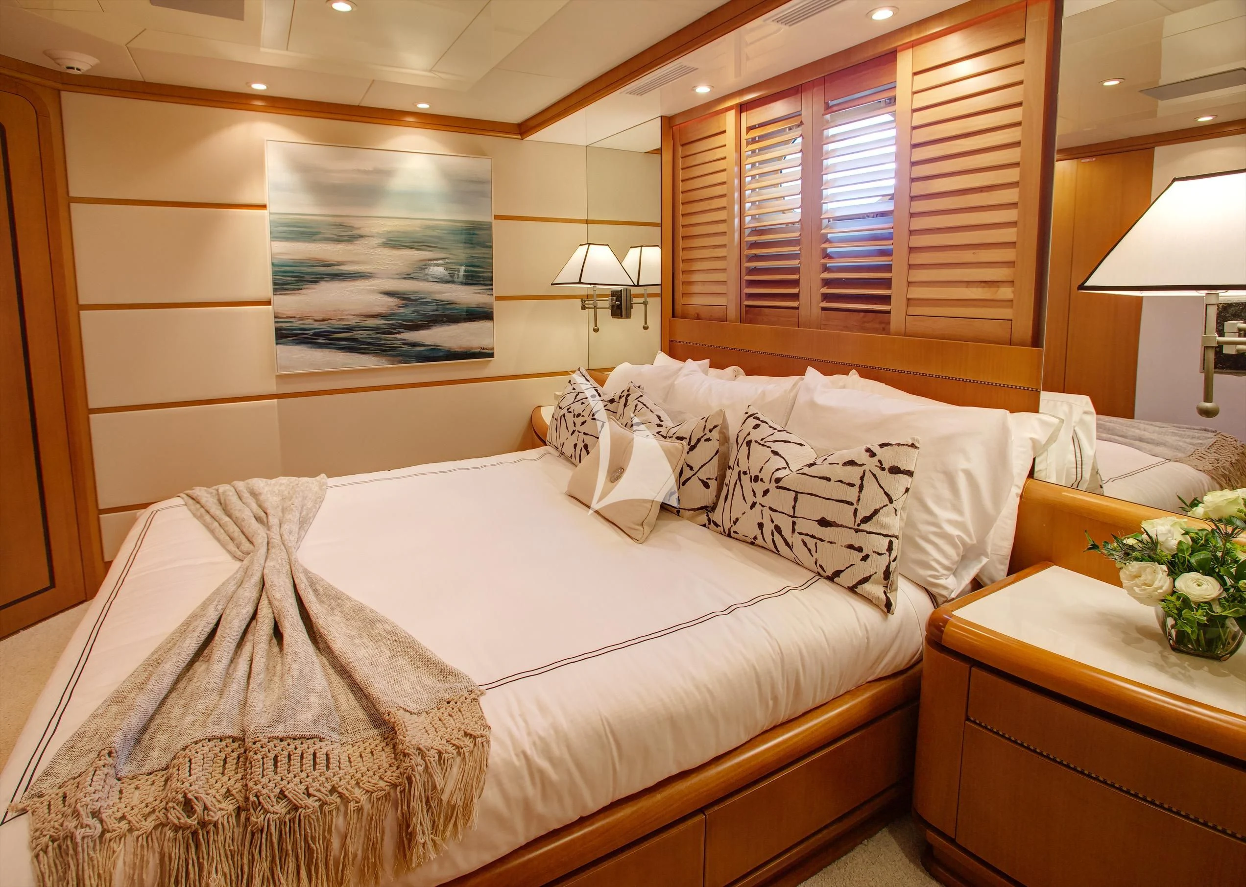 a bed with white sheets and pillows aboard XOXO Yacht for Charter