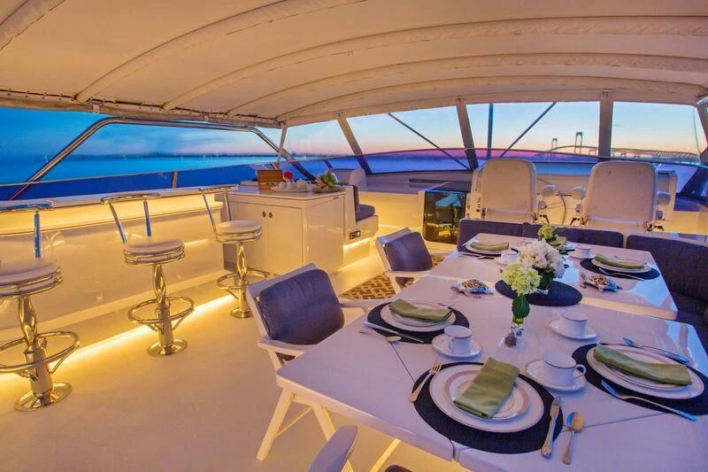 a dining room with a table set aboard XOXO Yacht for Charter