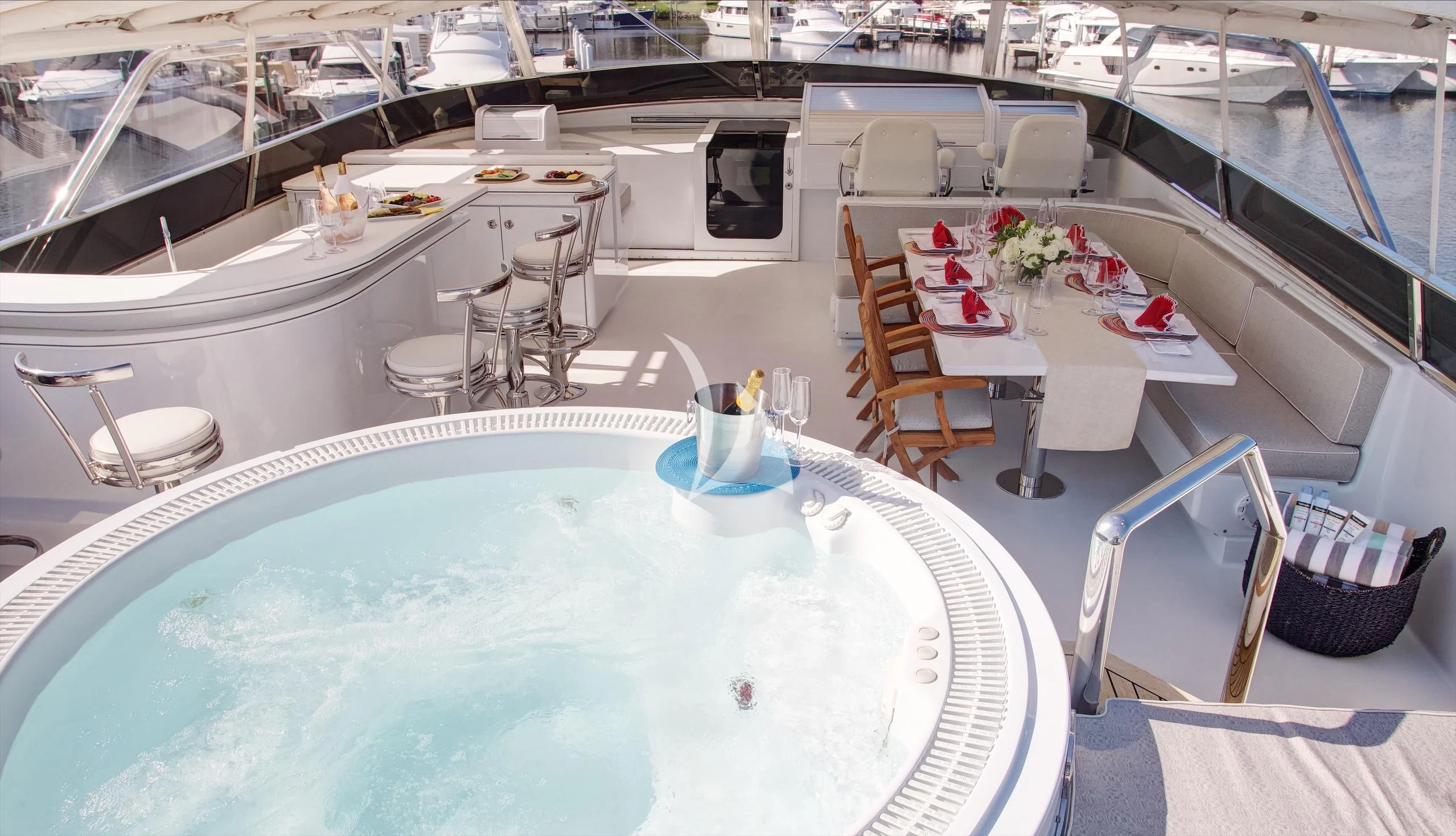 a pool with a table and chairs aboard XOXO Yacht for Charter