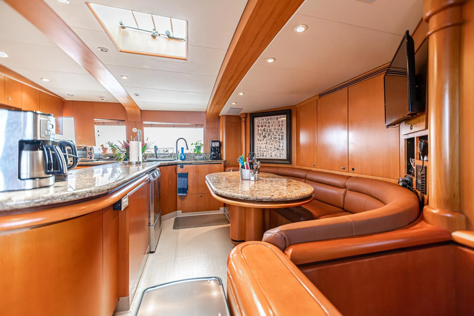 a kitchen with a table and couch aboard XOXO Yacht for Charter