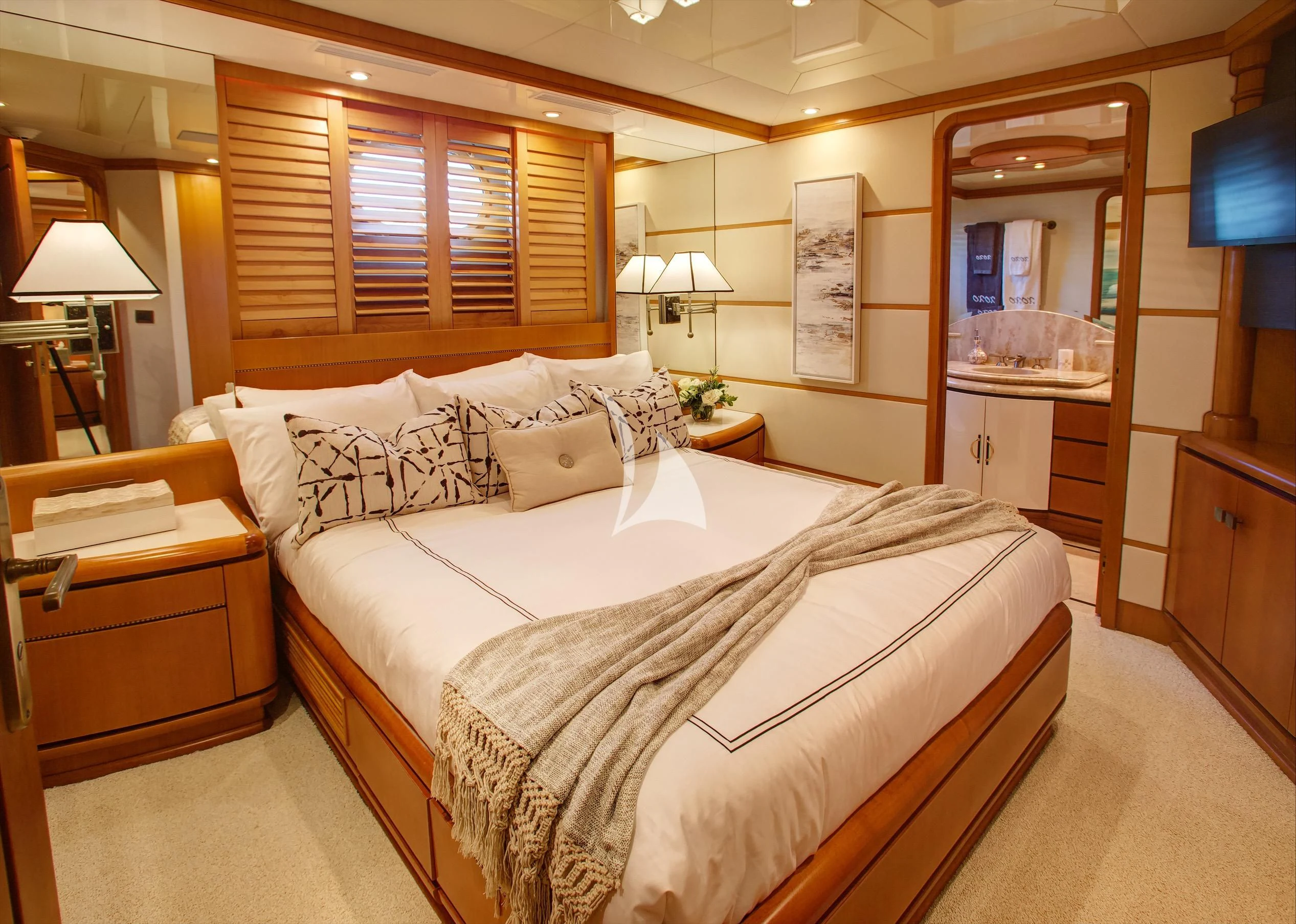 a bedroom with a bed and a mirror aboard XOXO Yacht for Charter