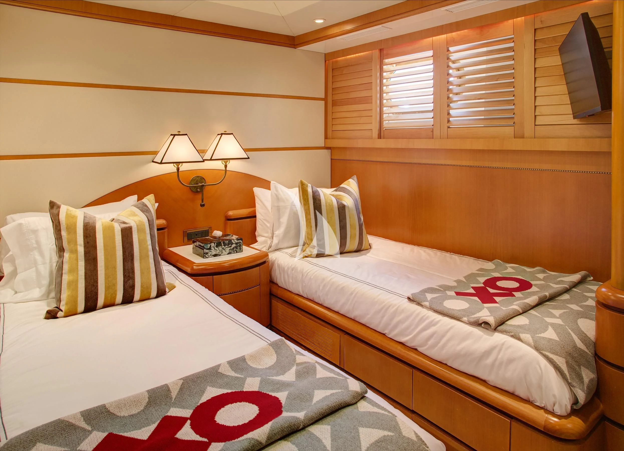 a couple of beds in a hotel room aboard XOXO Yacht for Charter