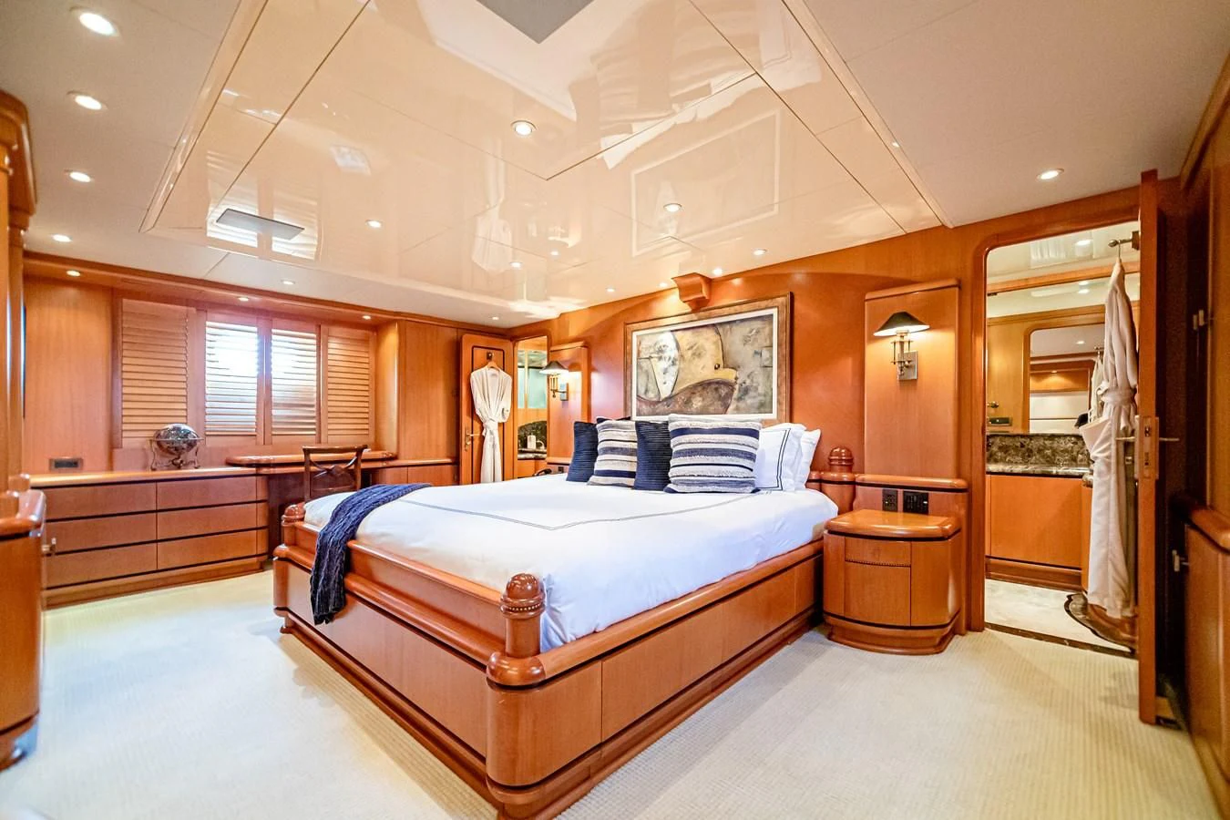 a bedroom with a bed and a mirror aboard XOXO Yacht for Charter