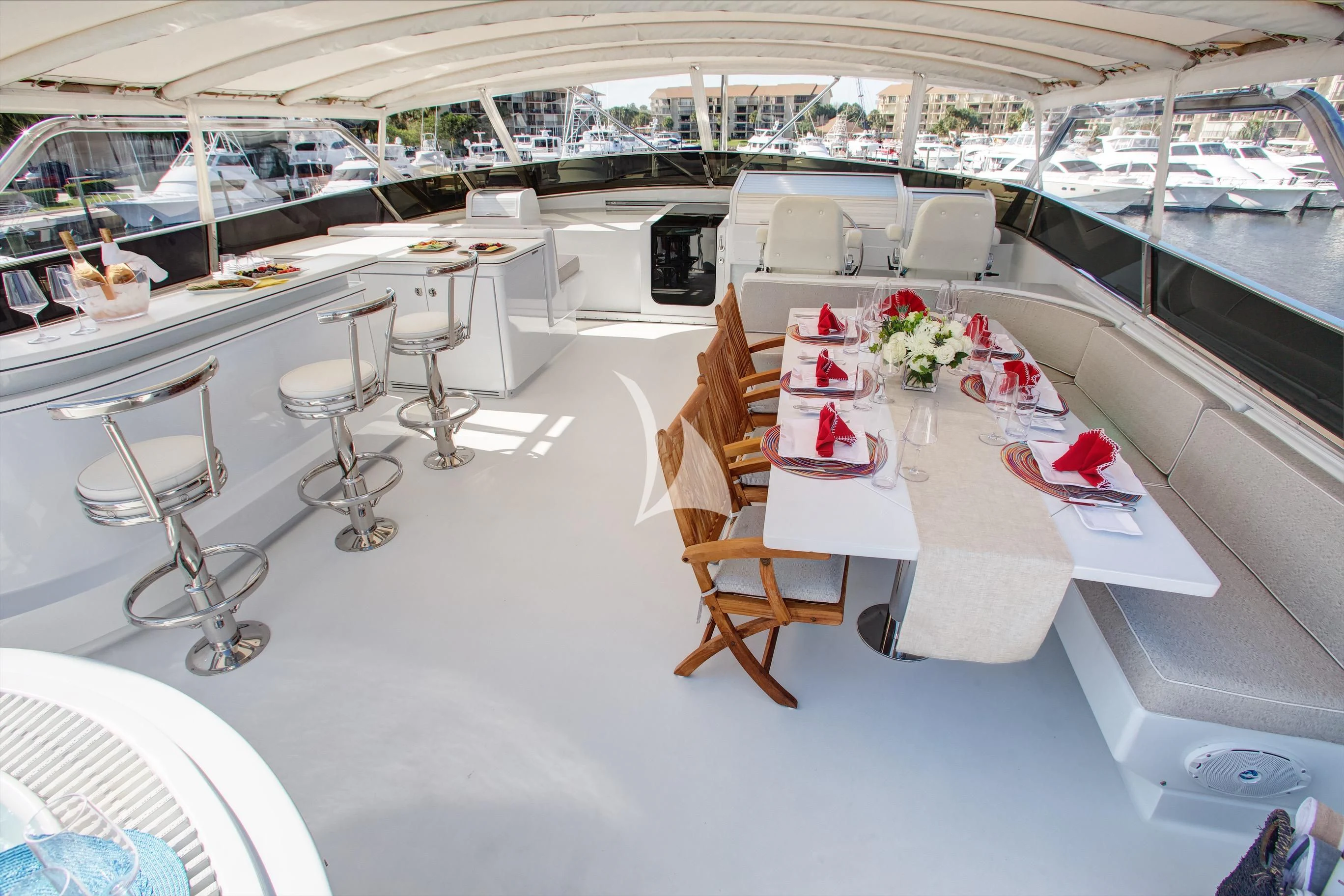 a room with tables and chairs aboard XOXO Yacht for Charter