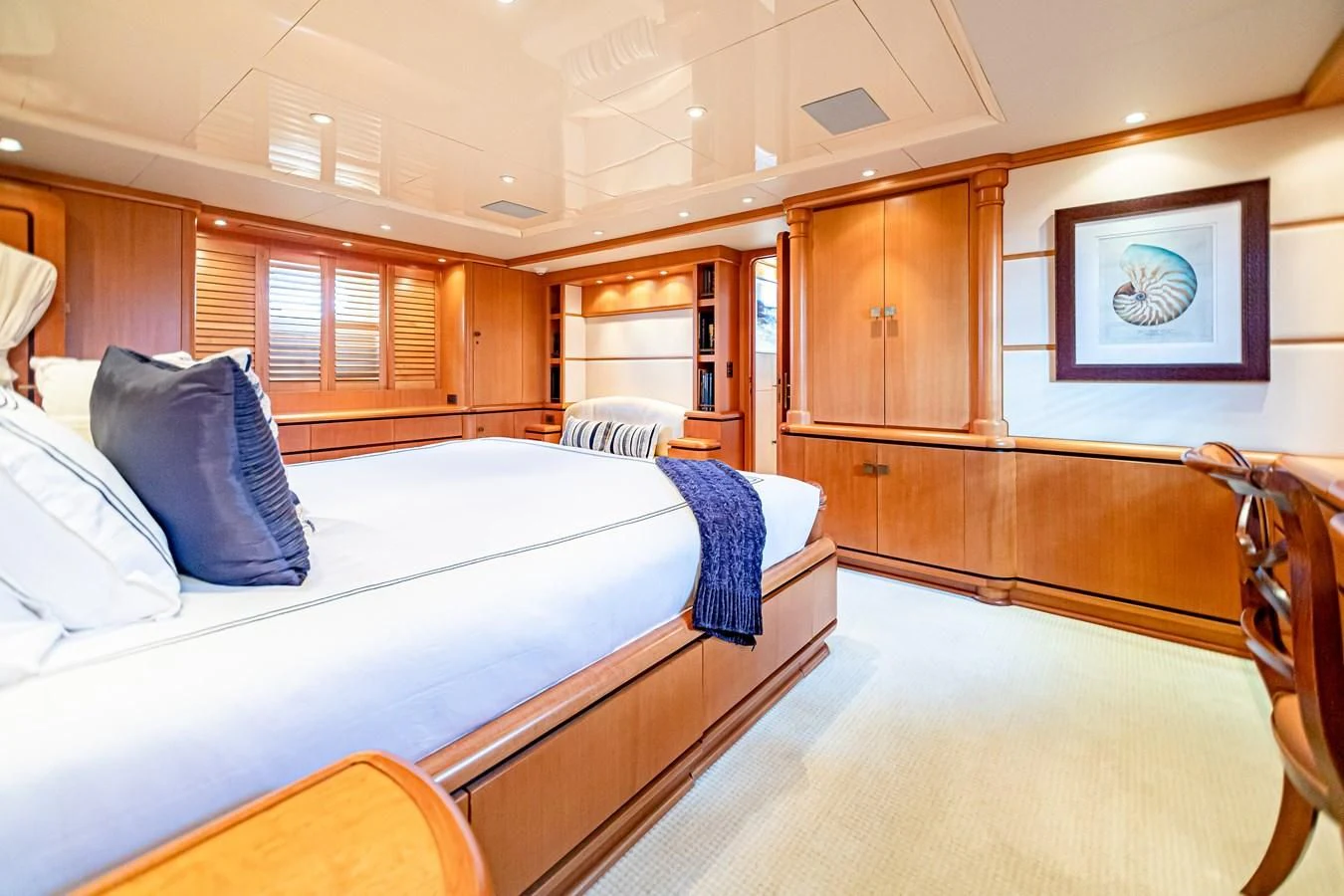 a room with a bed and a chair aboard XOXO Yacht for Charter