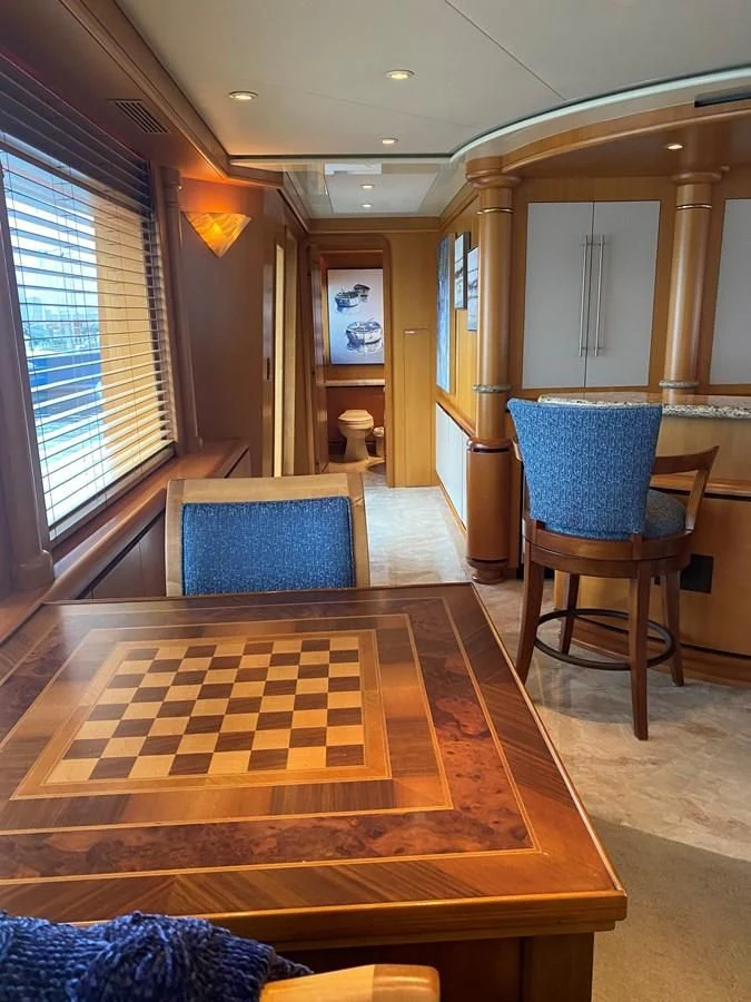 a living room with a wood floor aboard XOXO Yacht for Charter
