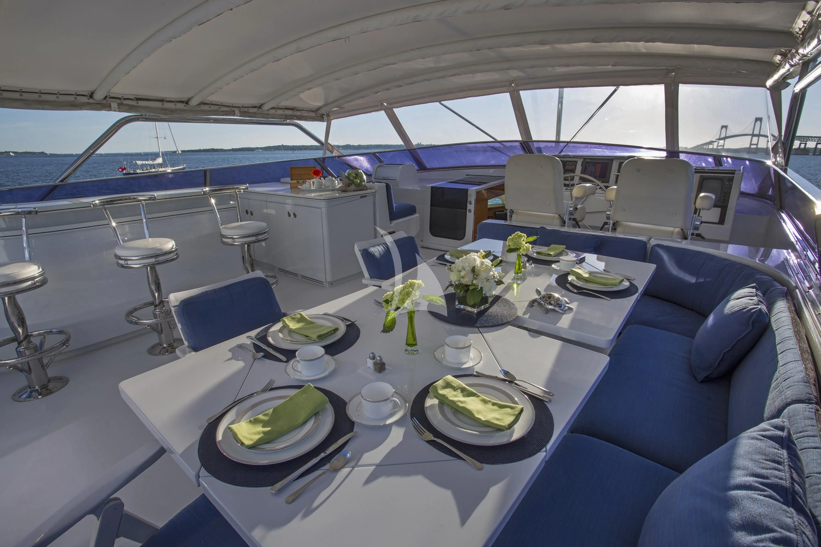 a table with plates and chairs aboard XOXO Yacht for Charter