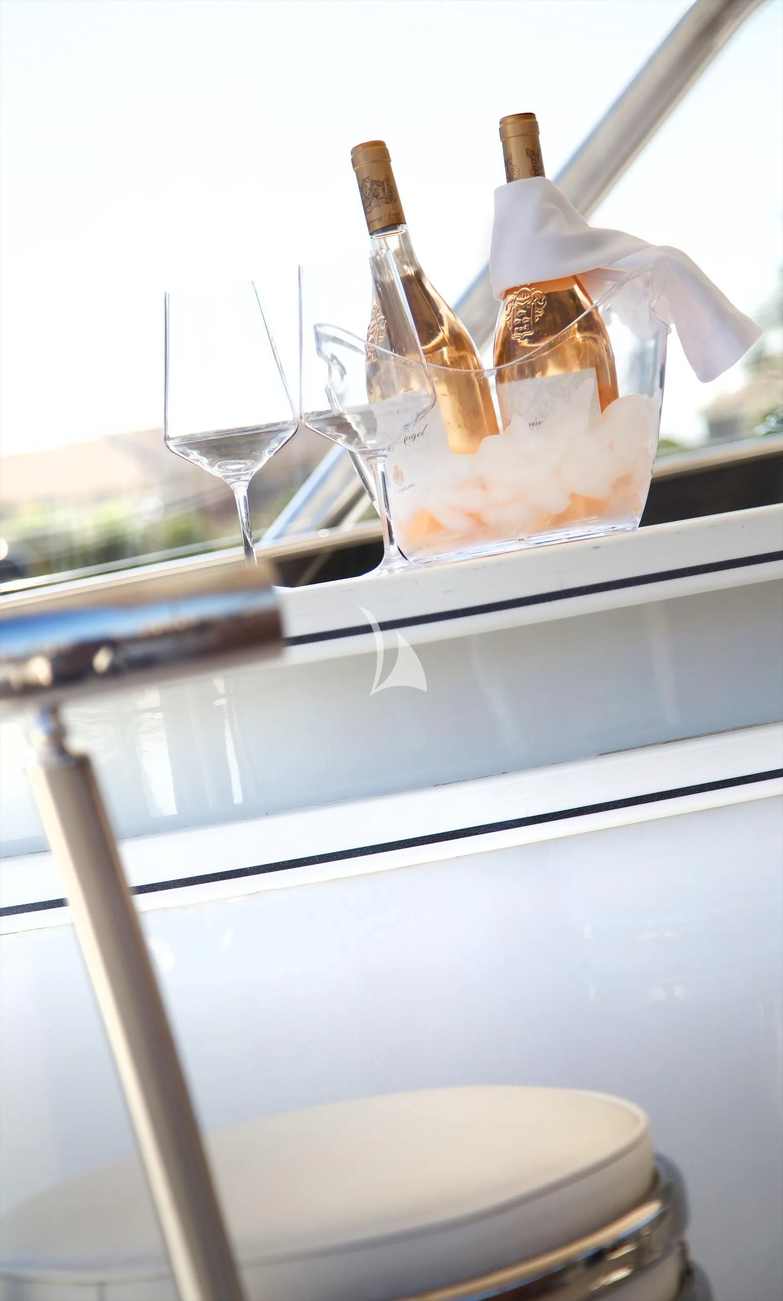 a bottle of liquor on a table aboard XOXO Yacht for Charter