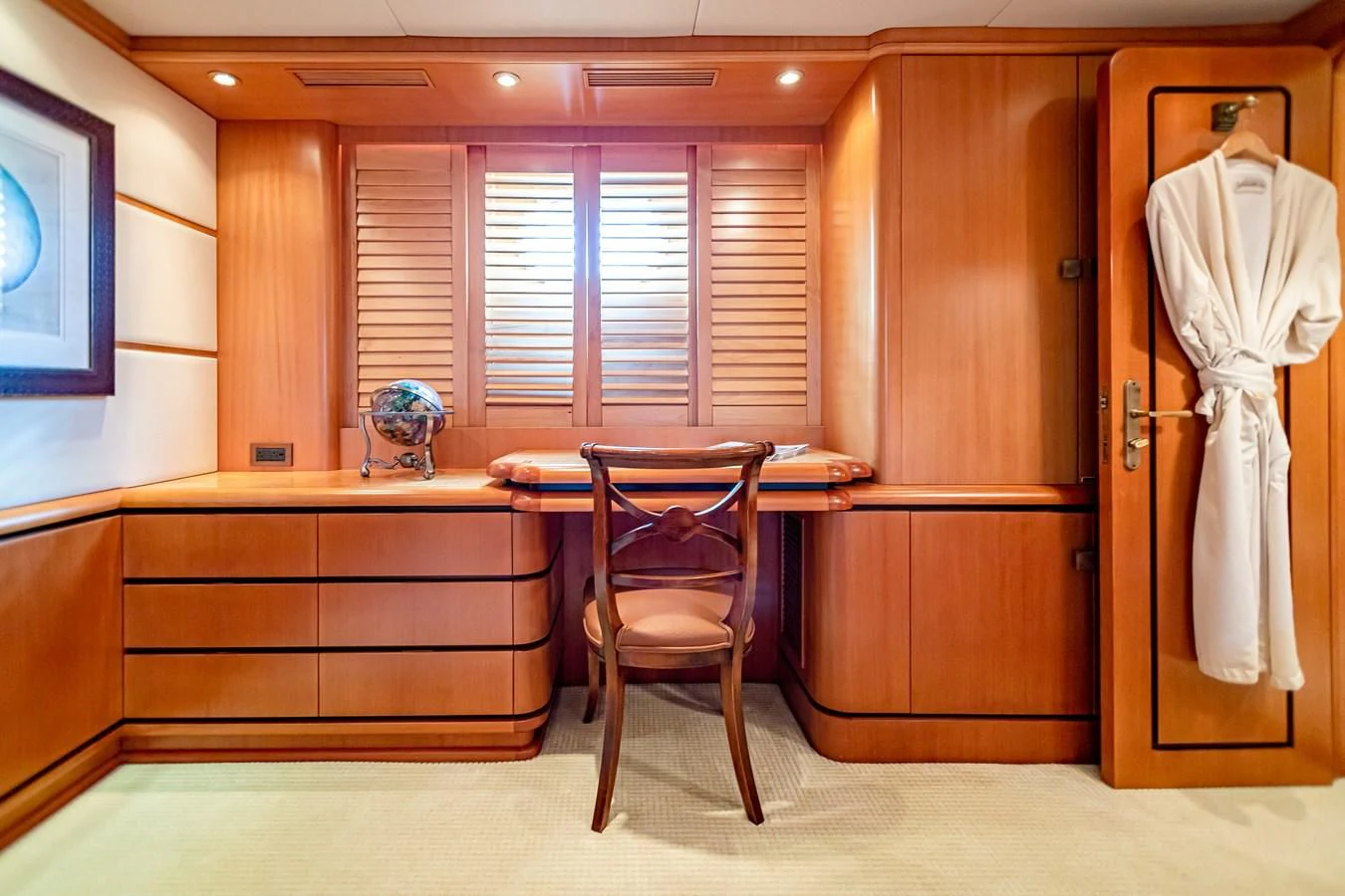a room with a chair and a desk aboard XOXO Yacht for Charter