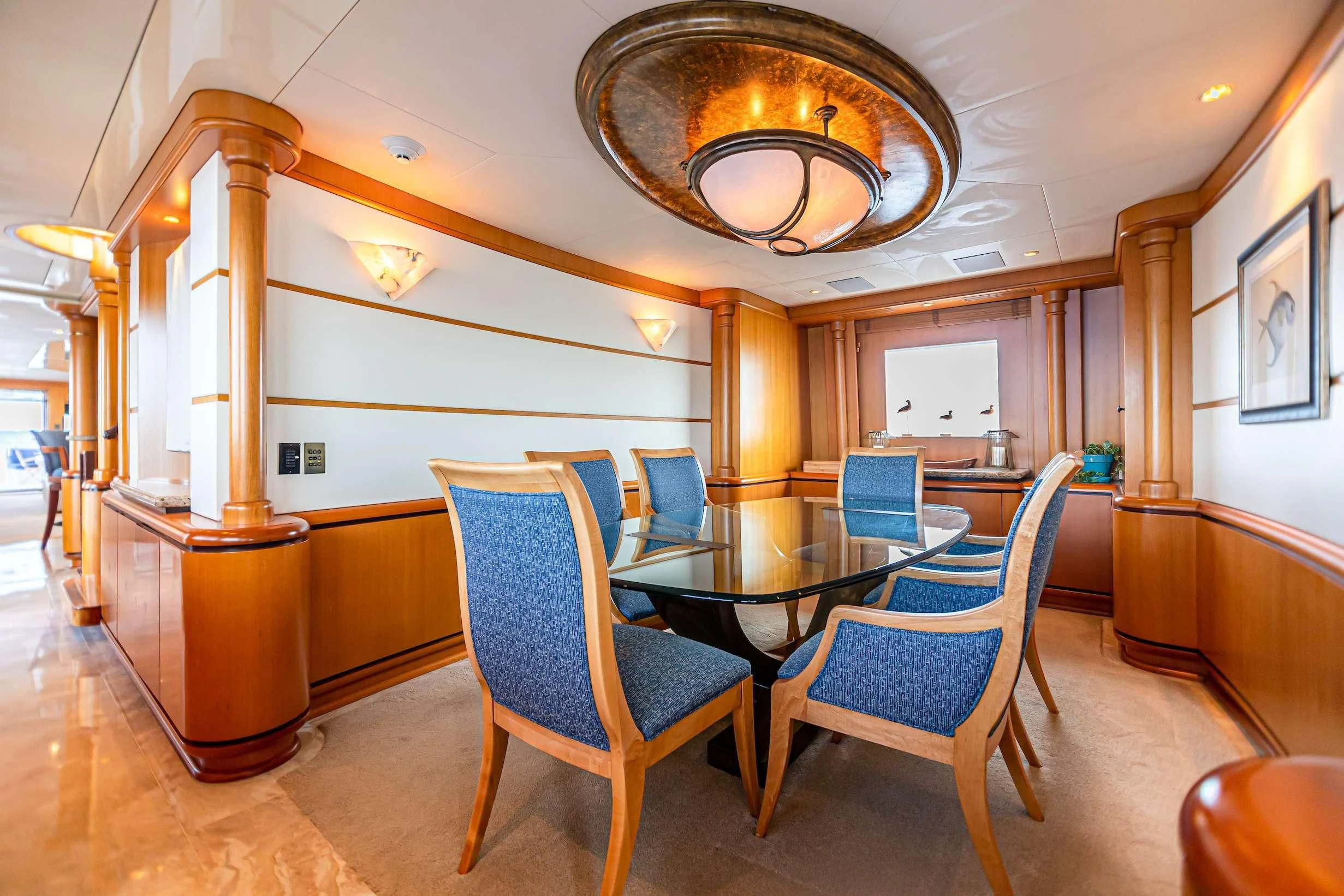 a large room with a table and chairs aboard XOXO Yacht for Charter