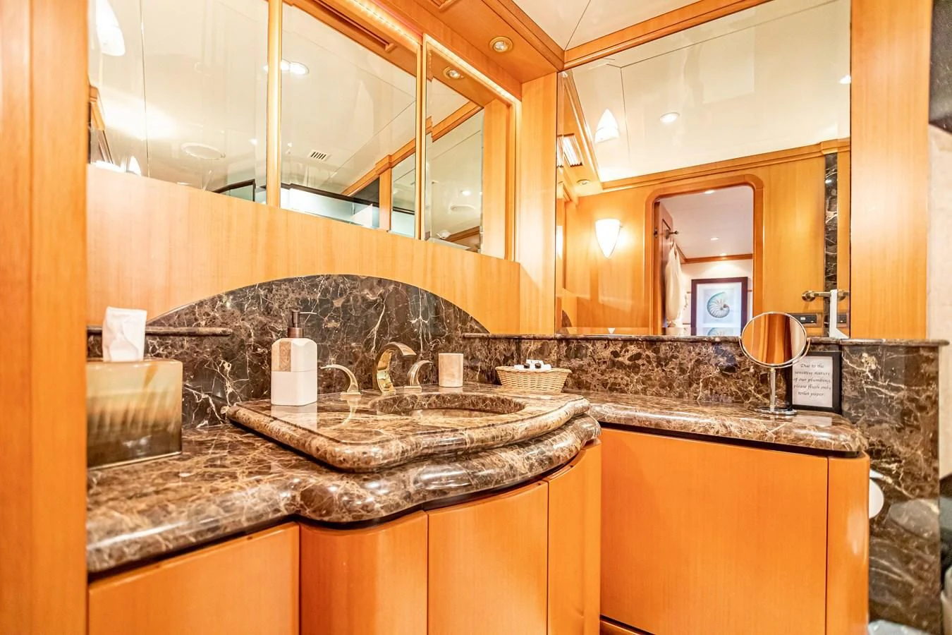 a bathroom with a marble counter top aboard XOXO Yacht for Charter