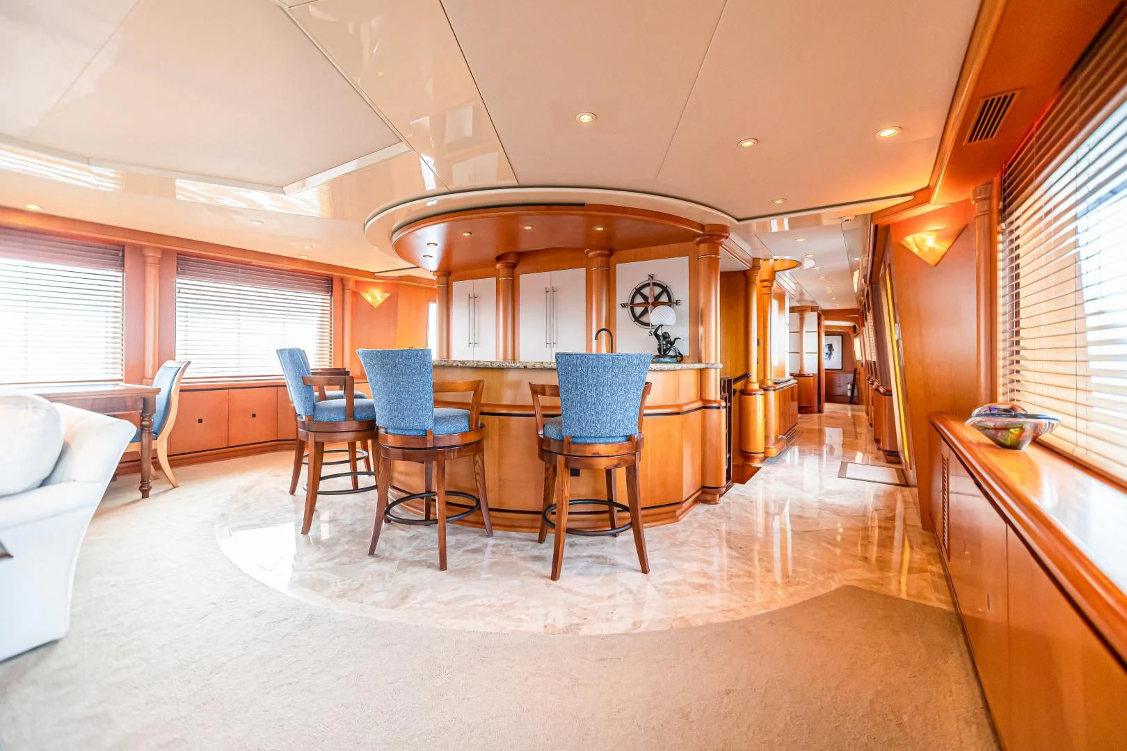a large room with a table and chairs aboard XOXO Yacht for Charter