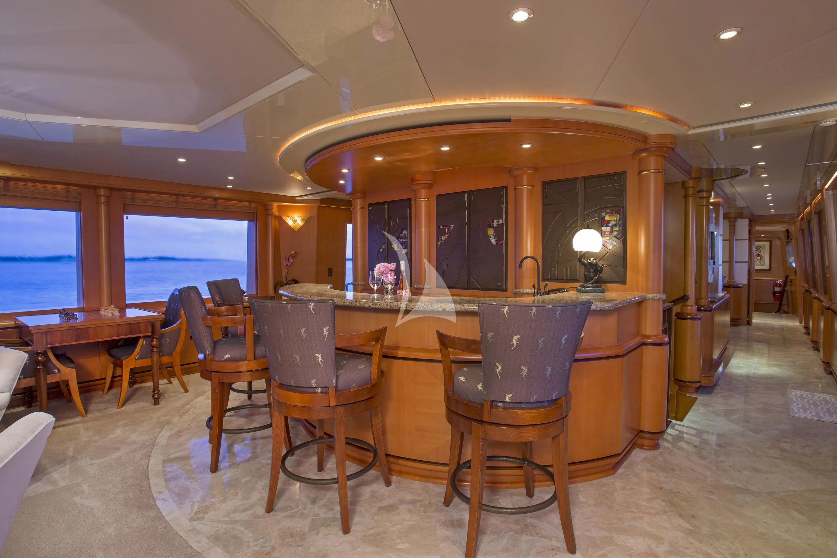 a room with tables and chairs aboard XOXO Yacht for Charter