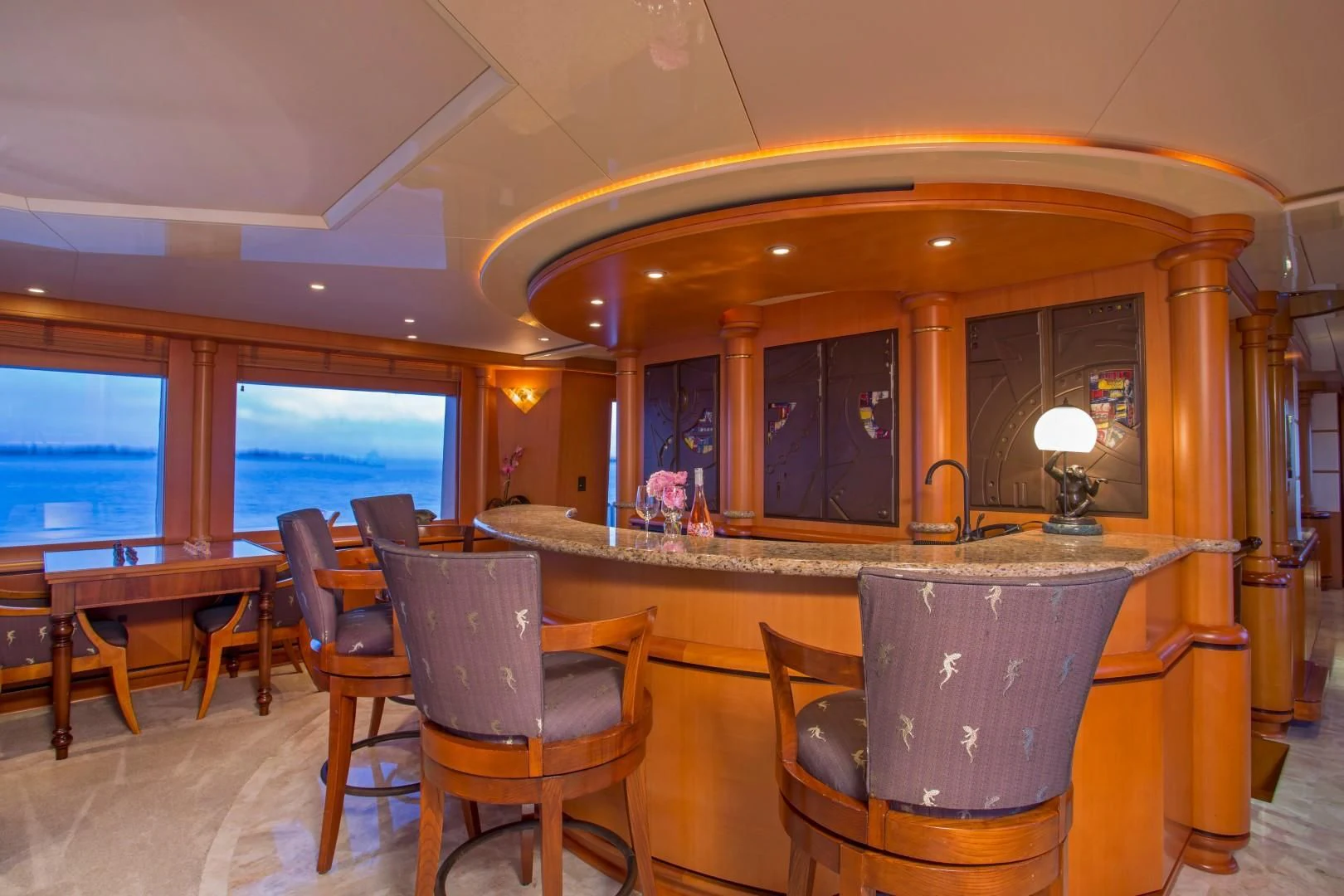 a bar with a bar and chairs aboard XOXO Yacht for Charter