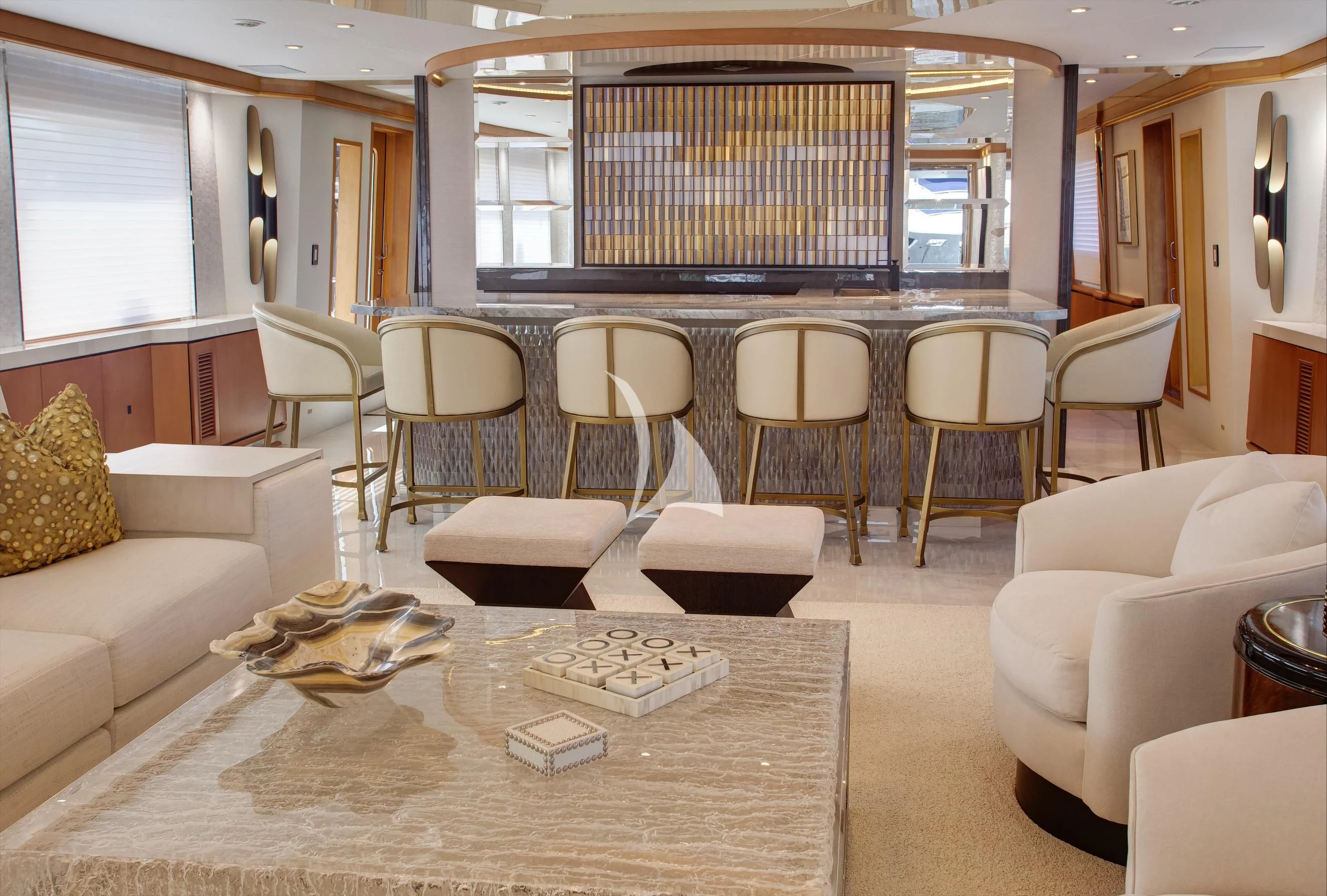a room with a table chairs and a couch aboard XOXO Yacht for Charter