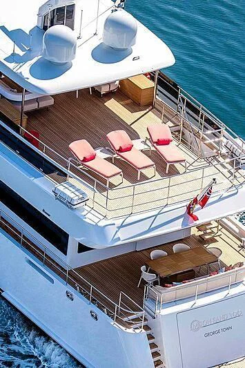 a large ship with a deck and chairs on it aboard GRAYCLIFFS Yacht for Sale