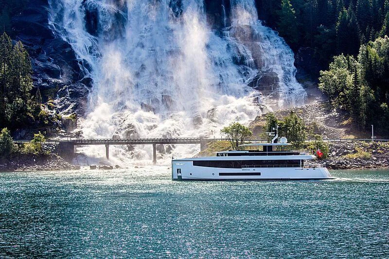a boat on a body of water with a bridge and a waterfall aboard GRAYCLIFFS Yacht for Sale