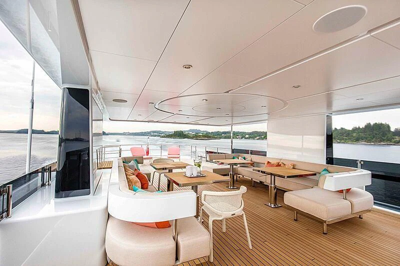 a room with a table chairs and a large window aboard GRAYCLIFFS Yacht for Sale