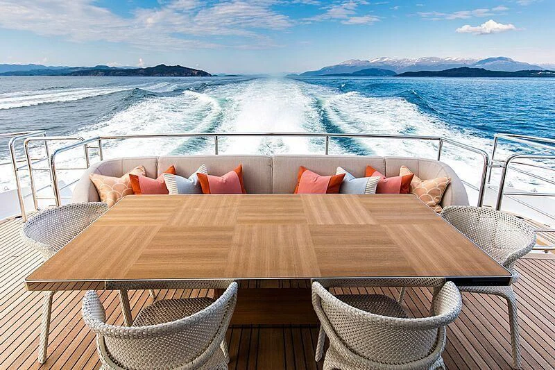 a table on a balcony overlooking the ocean aboard GRAYCLIFFS Yacht for Sale