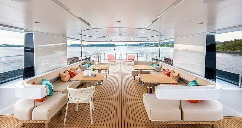 a room with a table chairs and a large window aboard GRAYCLIFFS Yacht for Sale
