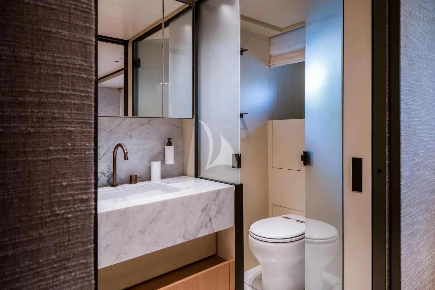a bathroom with a sink toilet and a mirror aboard AKIRA Yacht for Sale