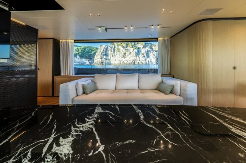 a large living room with a large window aboard AKIRA Yacht for Sale