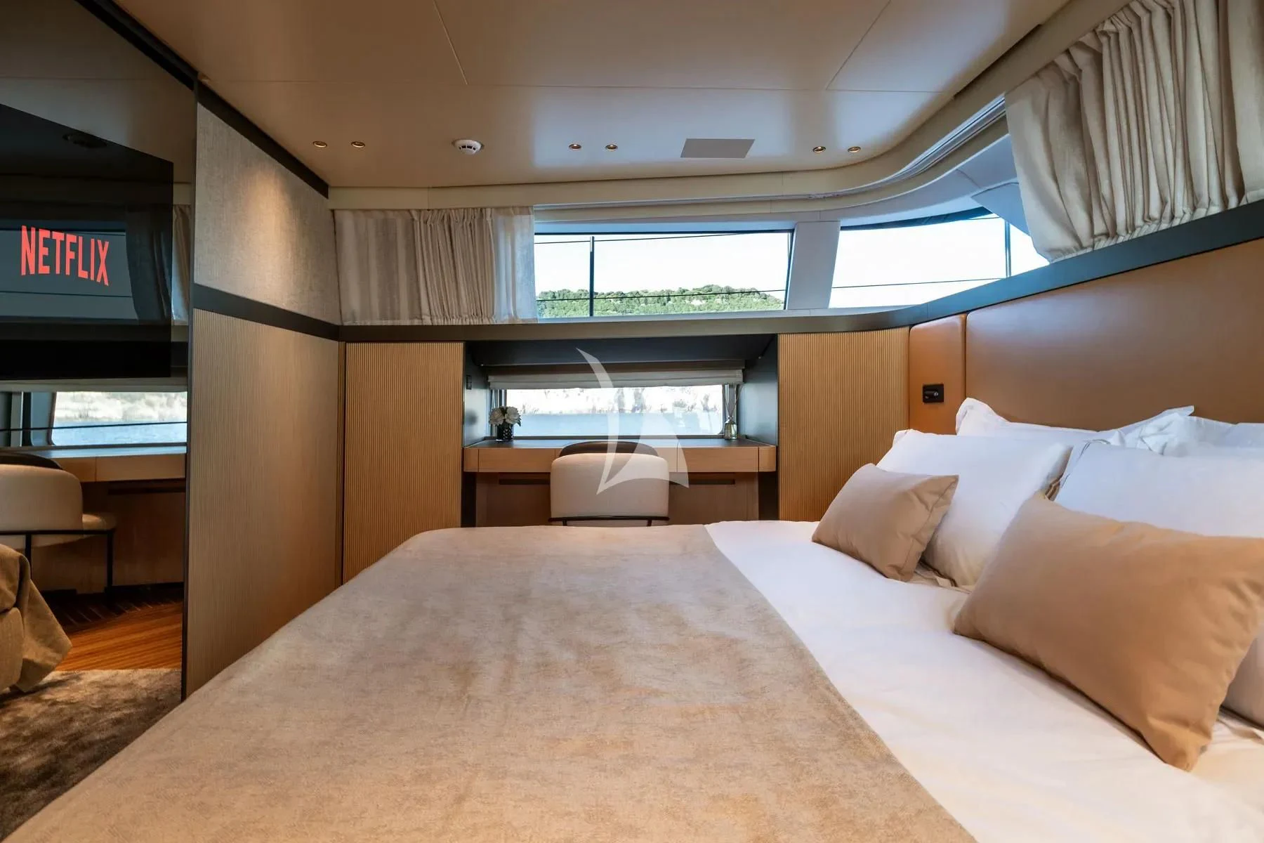 a bed with pillows and a tv aboard AKIRA Yacht for Sale