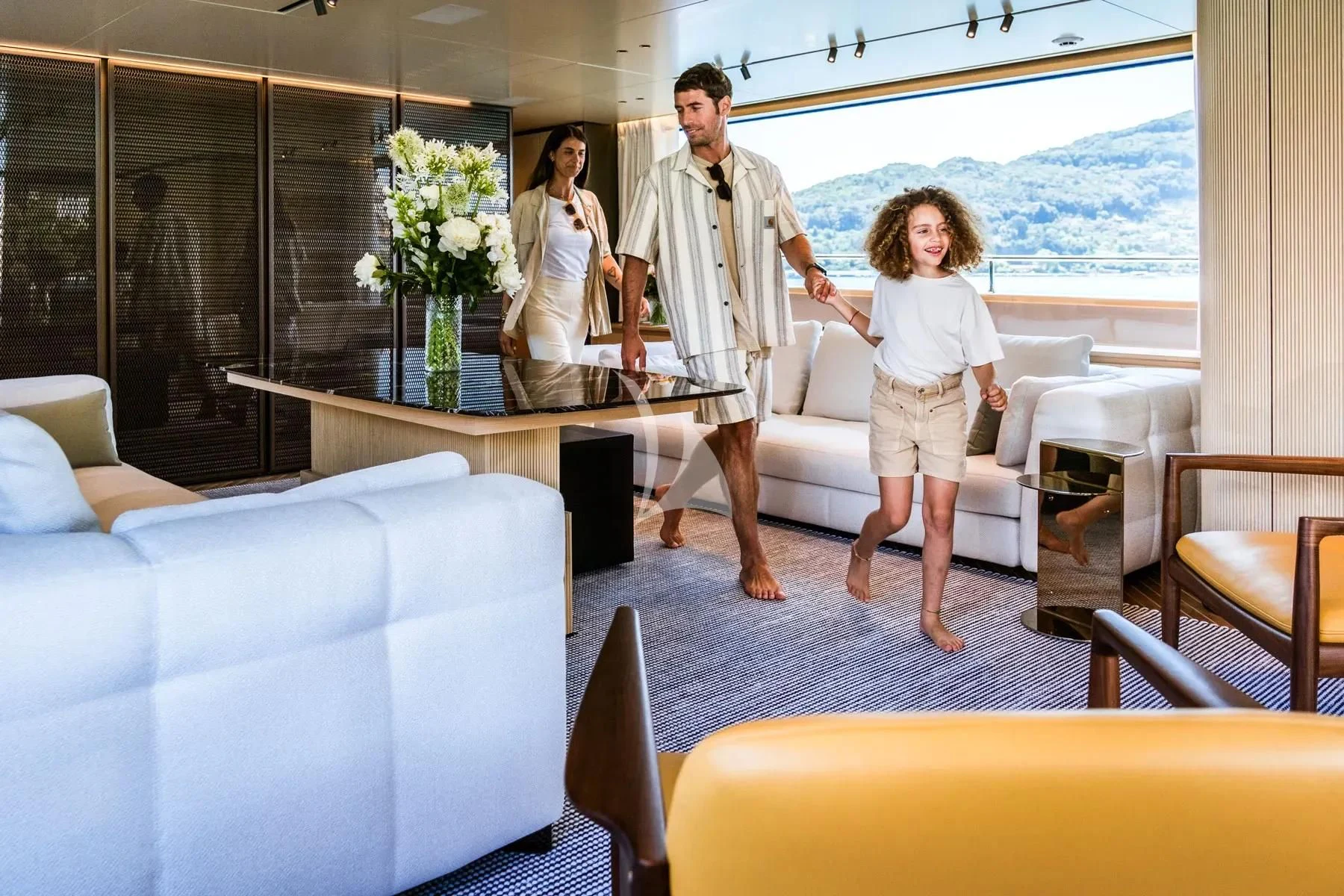 a man and woman standing in a room with a table and chairs aboard AKIRA Yacht for Sale