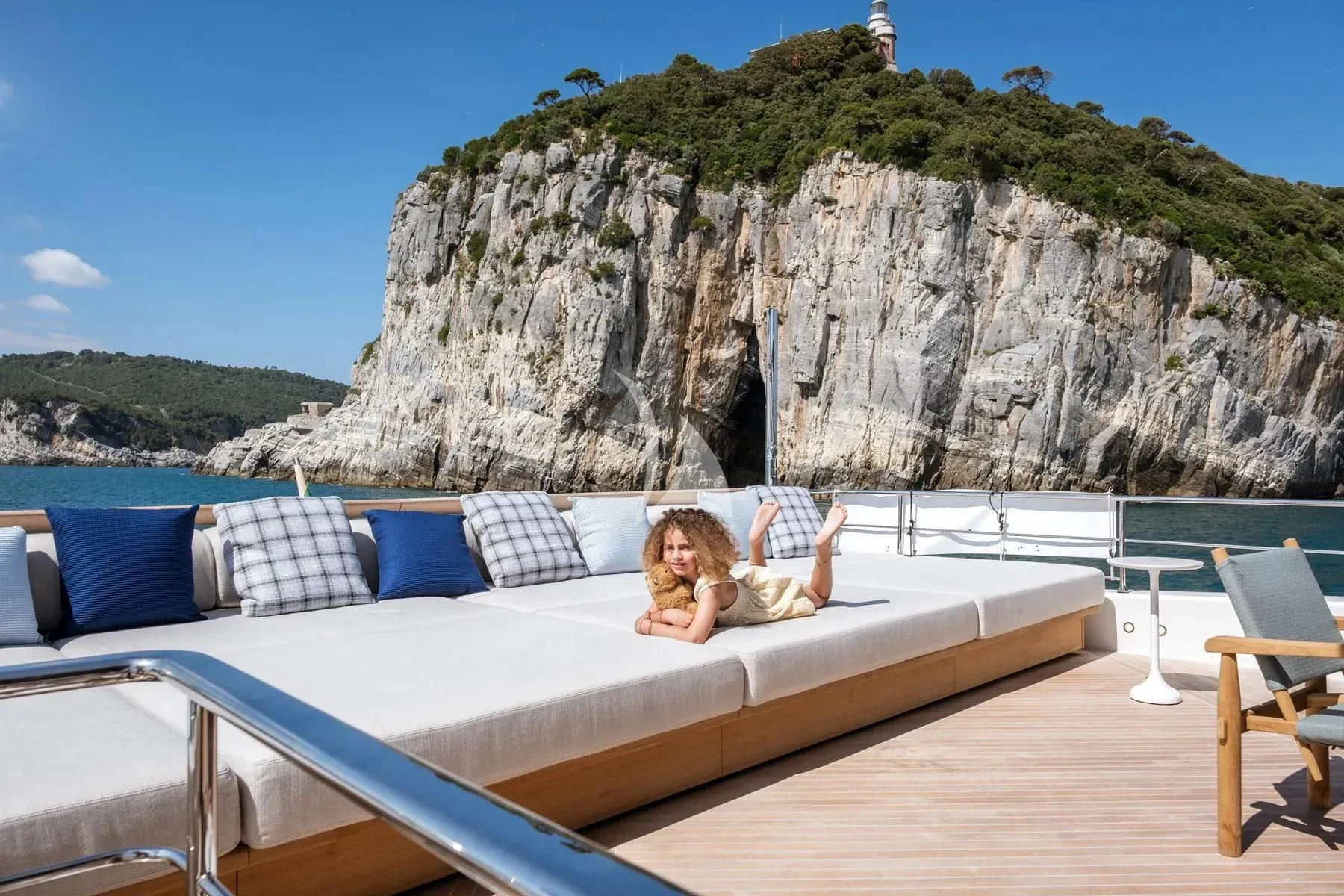 a person lying on a bed aboard AKIRA Yacht for Sale