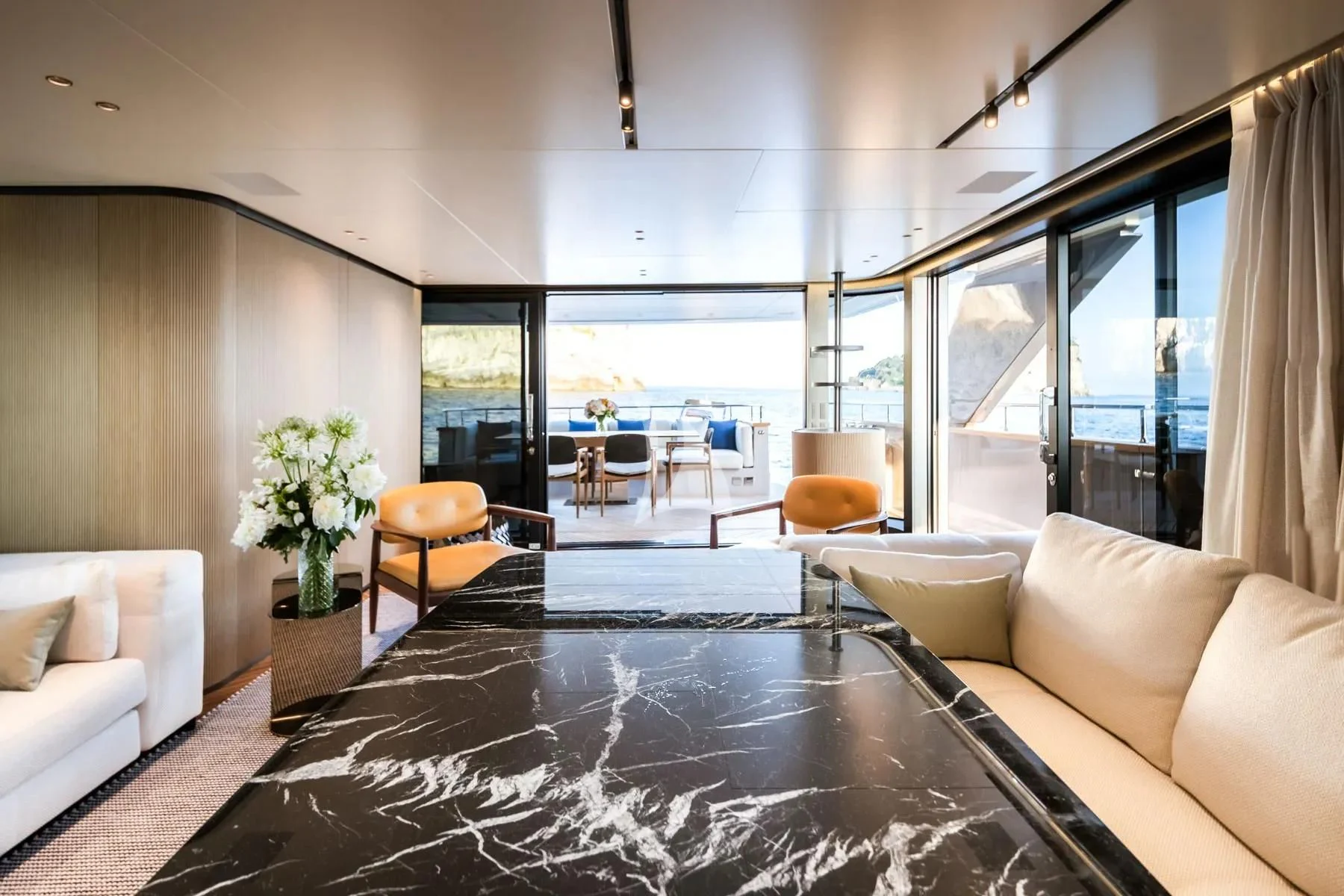 a living room with a large glass window aboard AKIRA Yacht for Sale