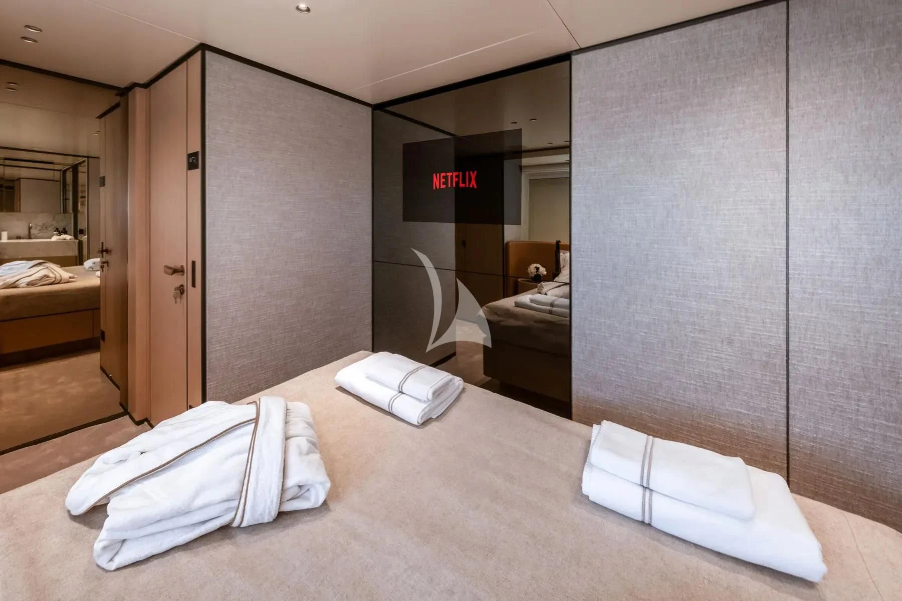 a hotel room with a bed and a mirror aboard AKIRA Yacht for Sale