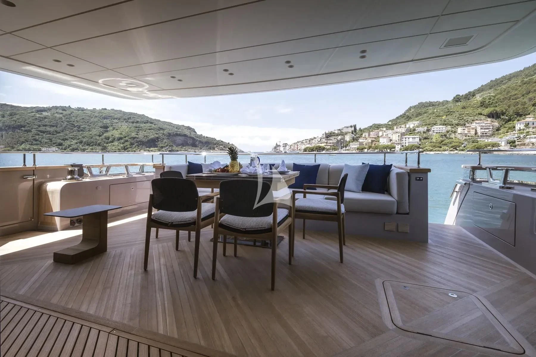 a deck with a table and chairs aboard AKIRA Yacht for Sale