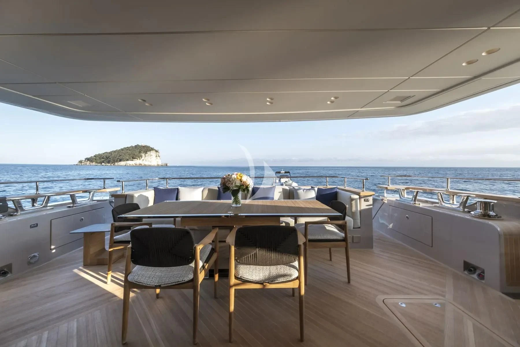 a table and chairs on a deck aboard AKIRA Yacht for Sale