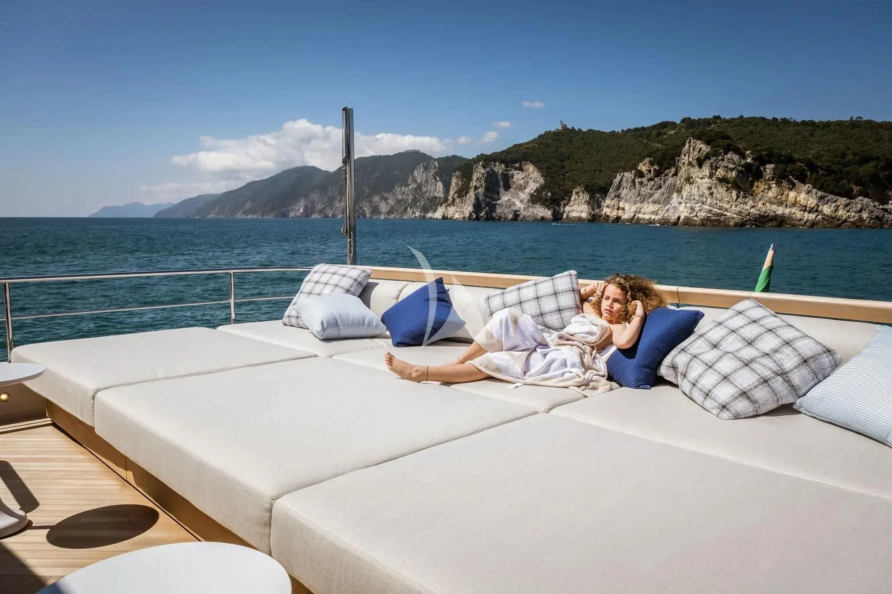a person lying on a bed aboard AKIRA Yacht for Sale