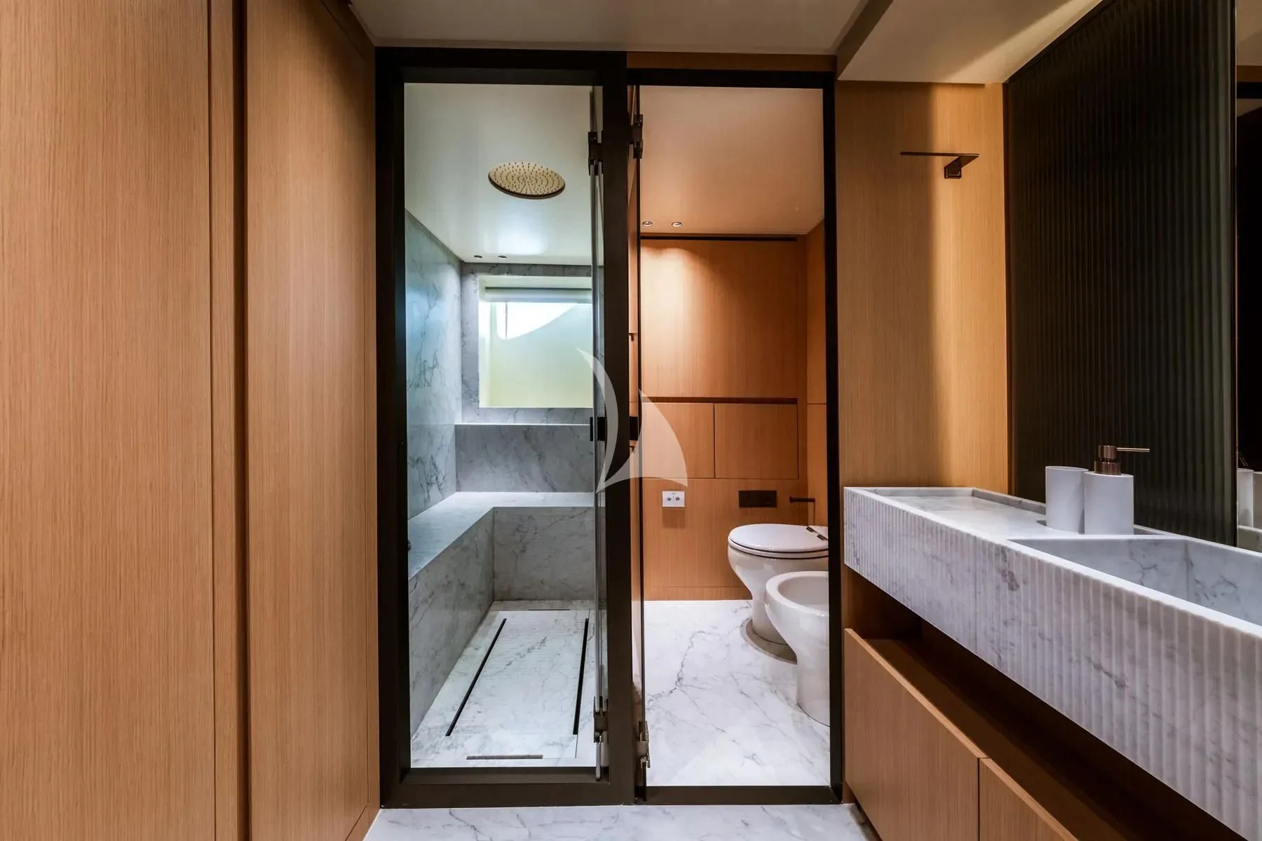 a bathroom with a glass shower aboard AKIRA Yacht for Sale