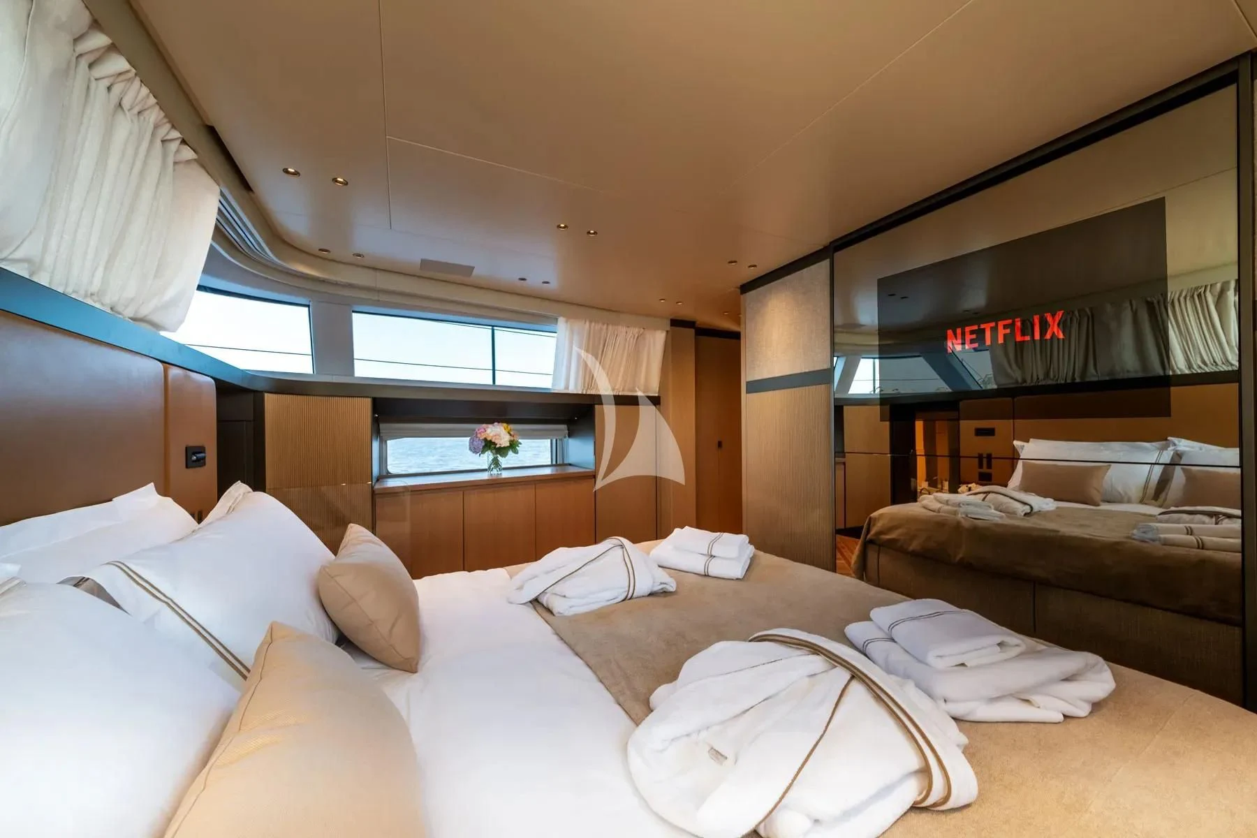 a room with a bed and a television aboard AKIRA Yacht for Sale