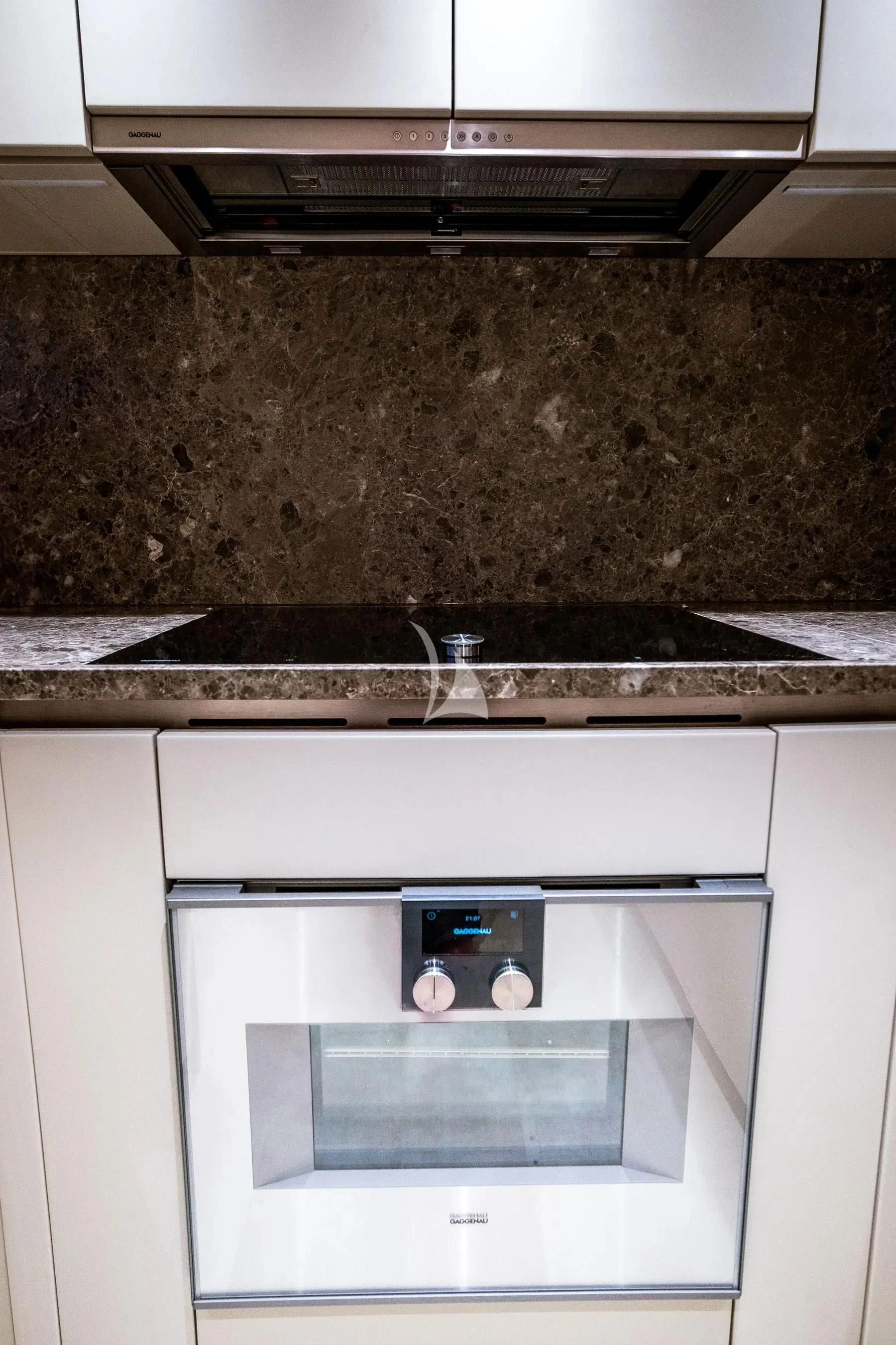 a kitchen with a silver stove and a silver faucet aboard AKIRA Yacht for Sale