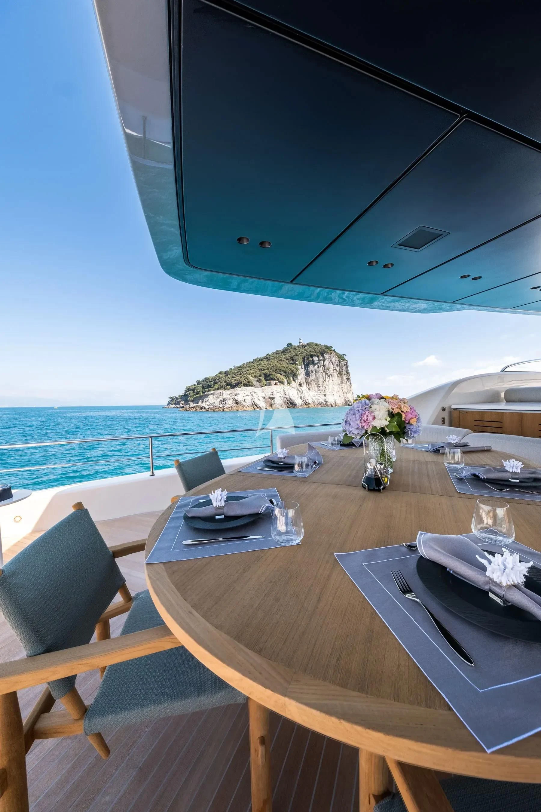 a table with plates and flowers on it aboard AKIRA Yacht for Sale