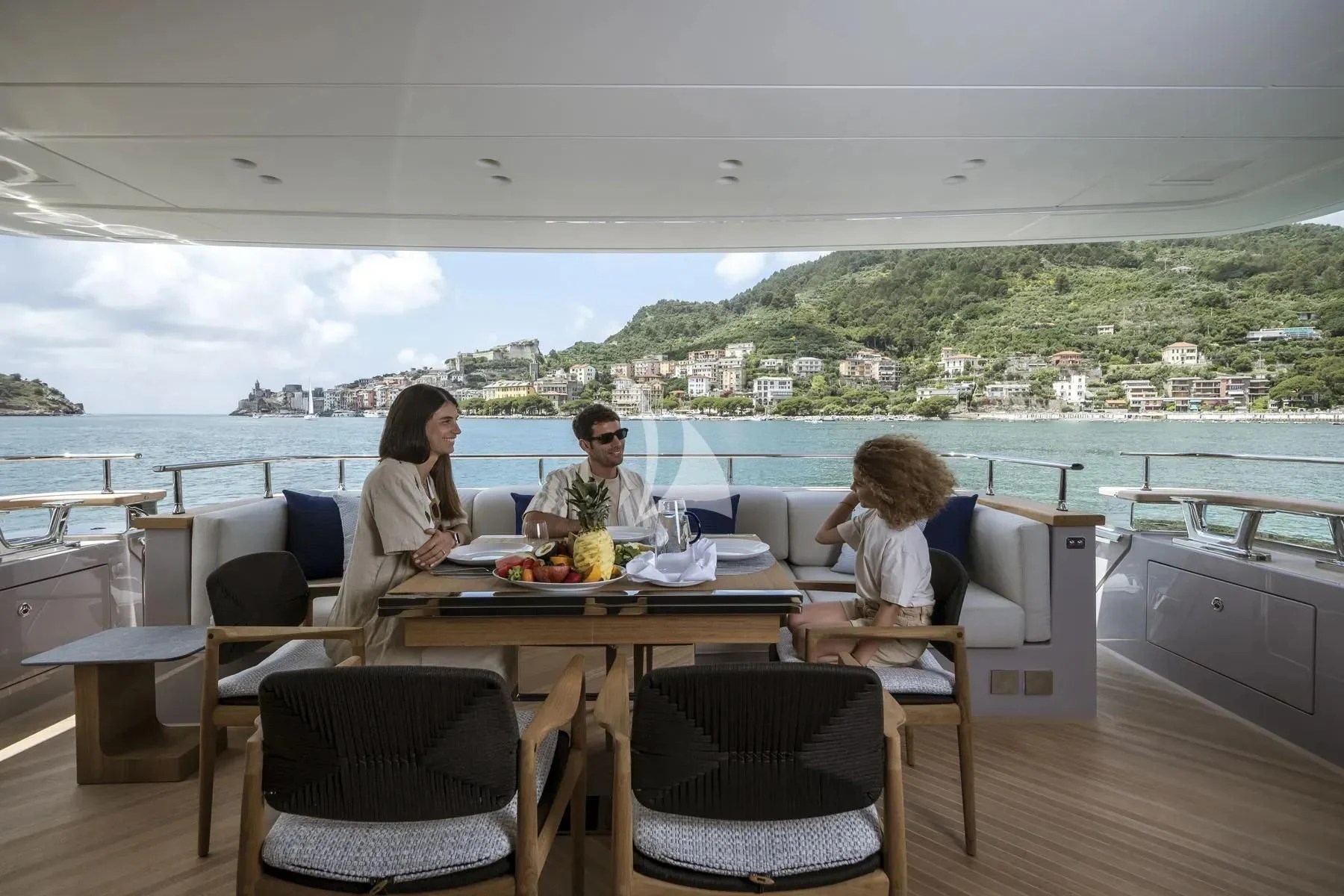 a family sitting at a table aboard AKIRA Yacht for Sale