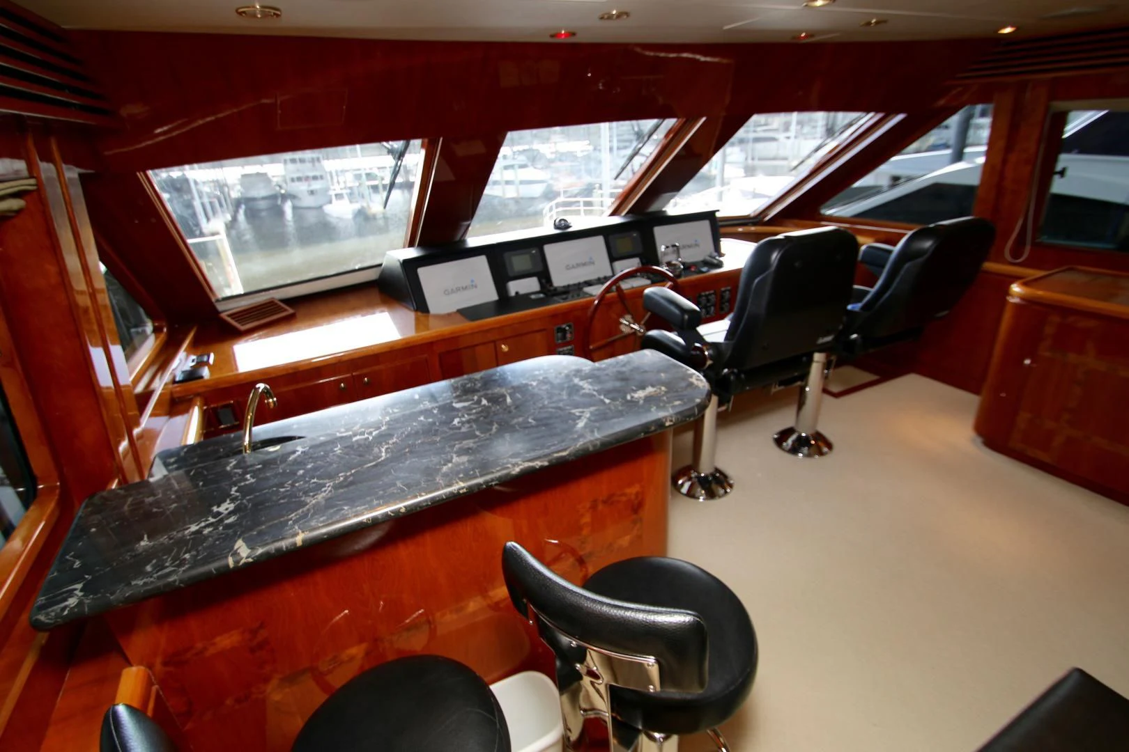 a room with a piano and chairs aboard KISMET Yacht for Sale