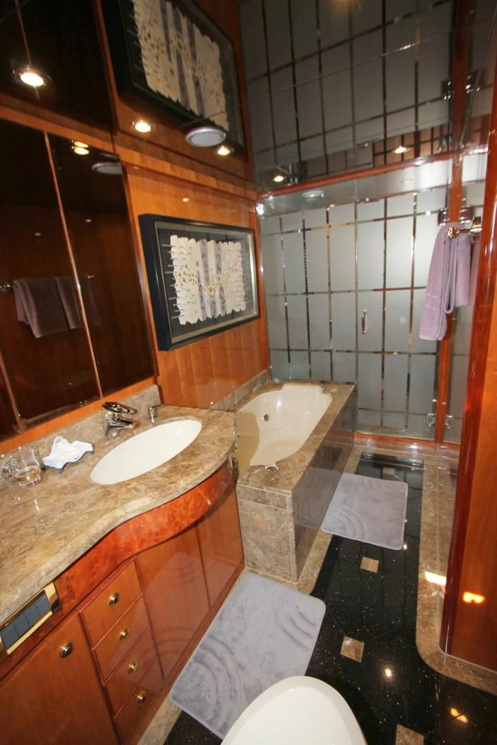 a bathroom with a sink and bathtub aboard KISMET Yacht for Sale