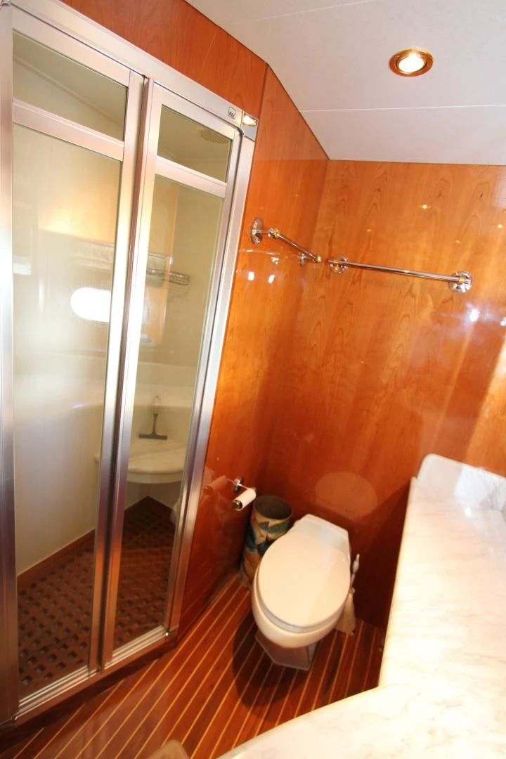 a bathroom with a glass shower aboard KISMET Yacht for Sale