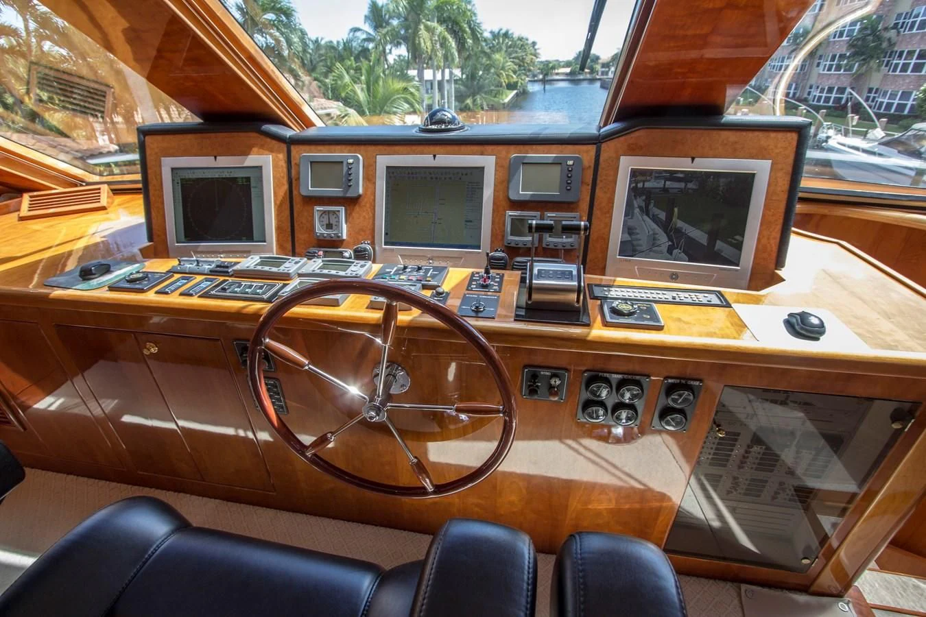 a wooden desk with computers and monitors aboard KISMET Yacht for Sale