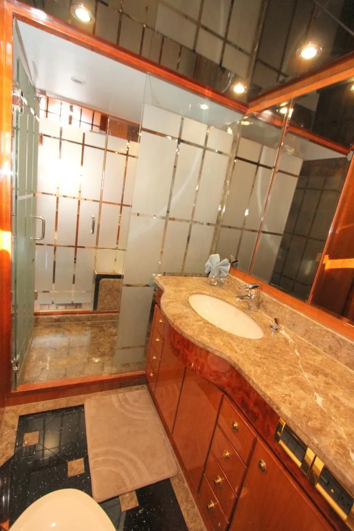 a bathroom with a sink and a mirror aboard KISMET Yacht for Sale
