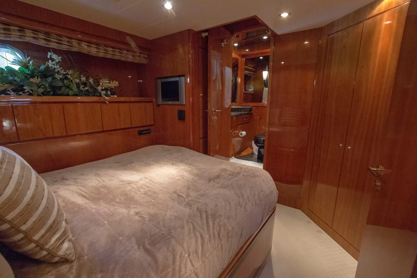 a bedroom with a bed and a television aboard KISMET Yacht for Sale