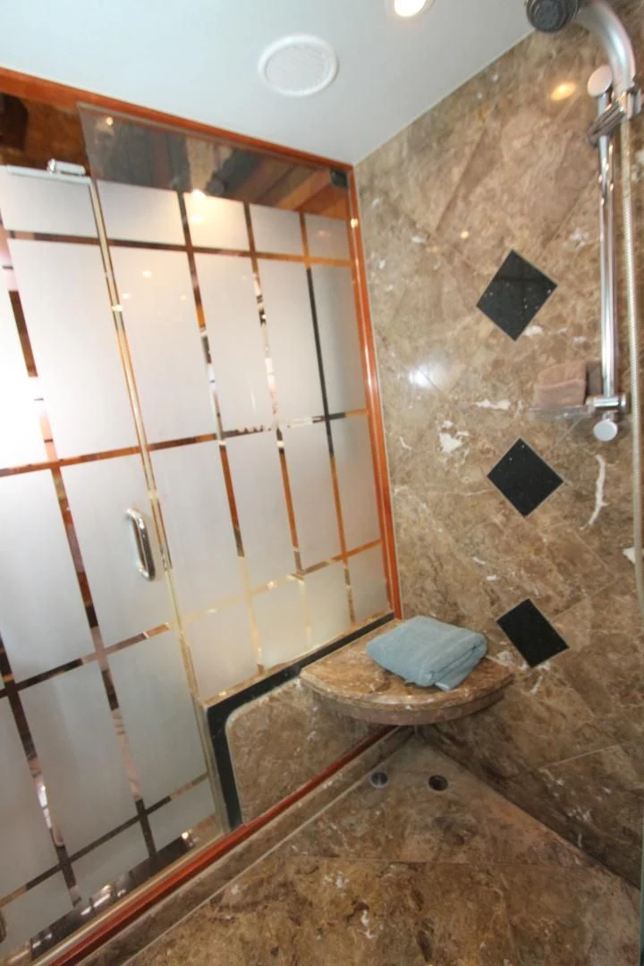 a bathroom with a shower and a sink aboard KISMET Yacht for Sale