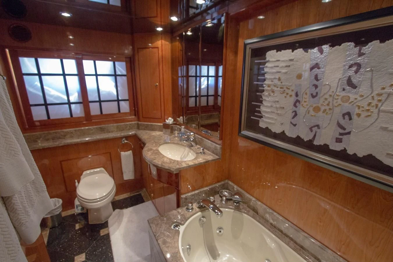a bathroom with a sink toilet and a bathtub aboard KISMET Yacht for Sale